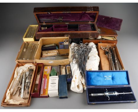 A collection of vintage medical instruments and medical scales, part sets including syringes, tubes, surgical scissors etc