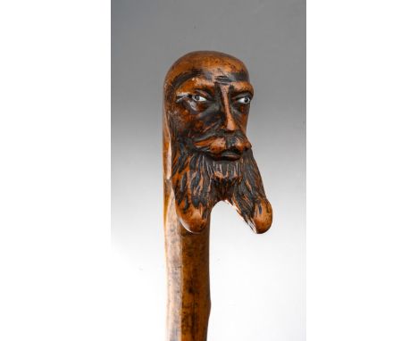 A late 19th / early 20th century bearded face thorn walking stick, with glass eyes, length 82cm (2)