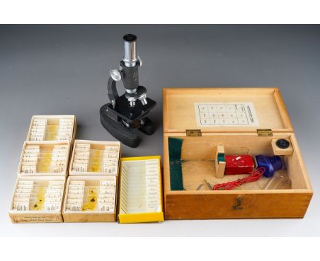 A cased Bijou Major 450x students microscope, together with five boxed sets of NBS microslides and a plastic case of microsco