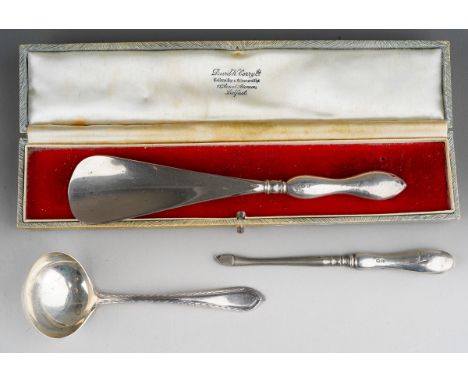 Three pieces of silver, comprising a steel shoe horn with silver handle, a silver handled manicure tool and a George V sauce 