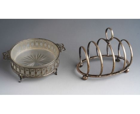 A George V silver pierced circular butter dish holder, on four supports, opaque glass liner, the silver hallmarked by Mappin 