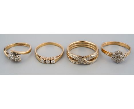 Four 9ct yellow gold and diamond rings, including a two-stone size E; a three-stone size K; a cluster ring size K1/2; and a c