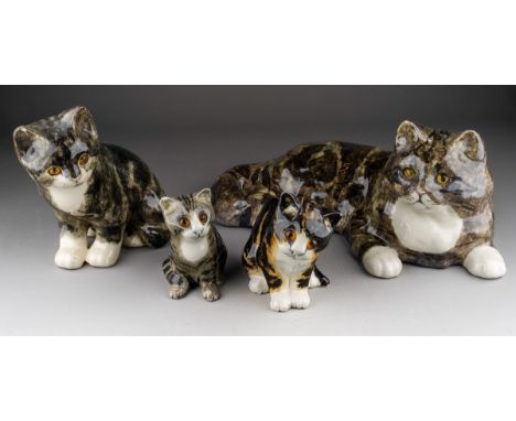 A Winstanley figure of a reclining cat and three Winstanley seated kittens, length of cat 39cm x height 16cm, tallest kitten 