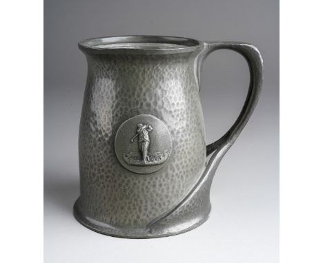 A Tudric pewter planished presentation mug, central plaque with a golfer, stamped to base and numbered 066