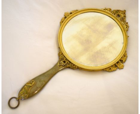 An early 20th century French gilt metal and enamel decorated hand mirror, the back decorated with three figures in a courtyar