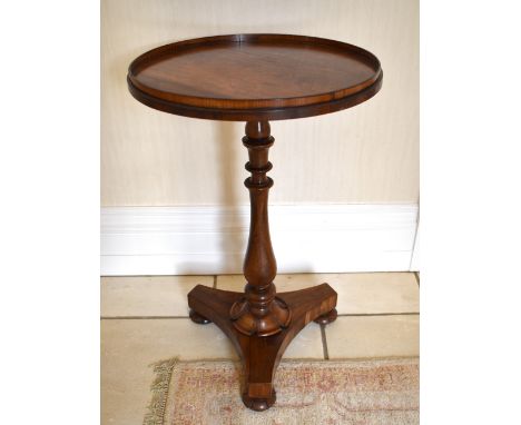 A William IV rosewood occasional table, the circular top with raised gallery above baluster knopped turned central column to 