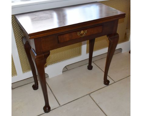 A George II style mahogany tea table of small proportions, the hinged rectangular top above frieze drawer, raised on cabriole