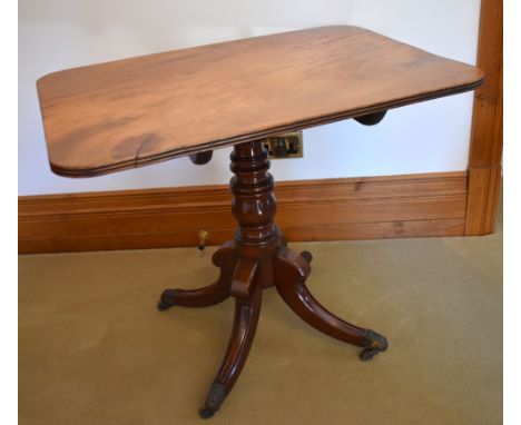 A late George III mahogany tripod occasional table, the rounded rectangular one piece top above ring turned central column, t