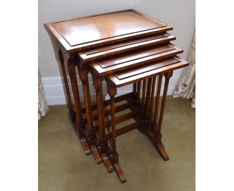 A reproduction mahogany quartetto nest of tables, each raised on twin turned supports to shaped stretchers, the largest table