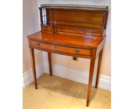 An Edwardian satinwood line inlaid and rosewood crossbanded lady's desk, the raised superstructure with three-quartered brass