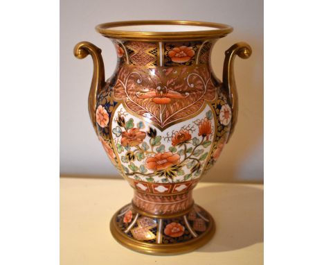 A 19th century Spode Imari decorated twin handled gilt heightened vase of baluster form, painted mark A227 to base, height 22