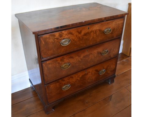 An early 19th century mahogany chest of three long drawers, raised on ogee bracket feet, height 84.5cm, width 91.5cm, depth 4