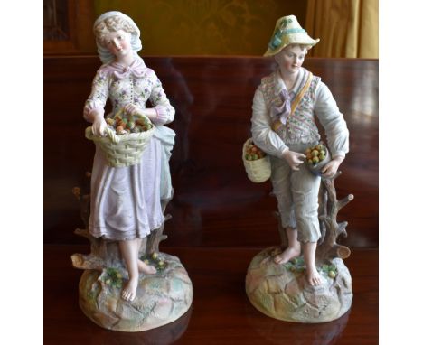 A large pair of late 19th century Continental bisque porcelain figures of a young gentleman and young lady, both gathering fr
