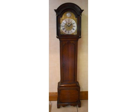 A George III oak longcase clock, the arched hood and dial with Roman numerals to the silvered chapter ring, subsidiary second