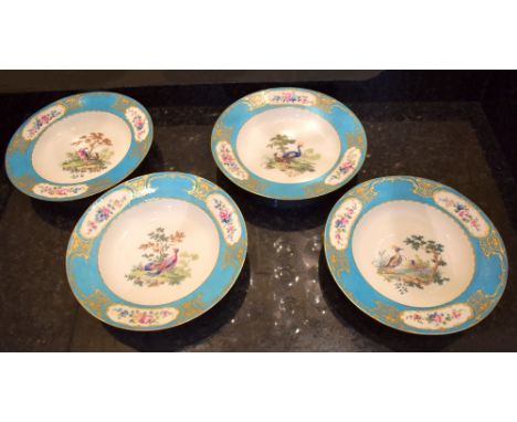 A set of four late 18th century Sèvres porcelain bowls, each with bleu celeste floral decorated border and central panel depi