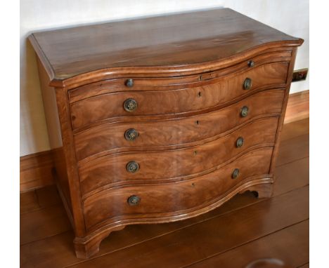 A George III mahogany serpentine chest, the chevron strung crossbanded shaped moulded top above brushing slide set with green