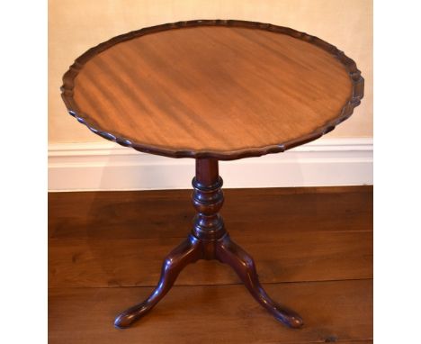 A George III mahogany piecrust top circular tilt-top occasional table, the one piece top above ring turned central column to 