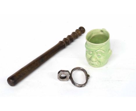 Early 20th century Police items to include wooden baton/night-stick, single Hiatt handcuff and 20th century green porcelain P