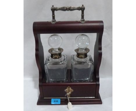 A tantalus of recent manufacture, the pair of decanters with silver collars. 15½' high