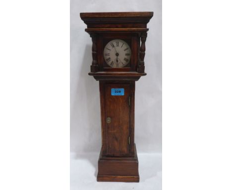 An oak miniature longcase clock, the enamel dial with Roman numerals and subsidiary seconds. 21' high