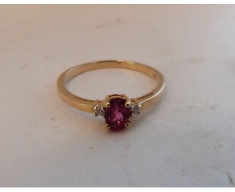 A pink tourmaline and white stone ring. In gold marked 375. Size O½. 1.6g gross