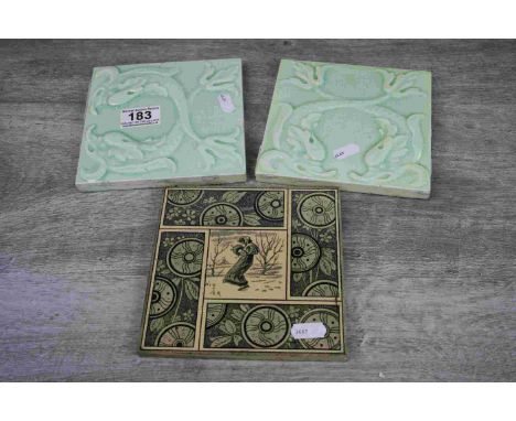 Pair of Art Nouveau square tiles, depicting stylised fish in relief, tails raised and crossed, pale green glaze, dimensions a