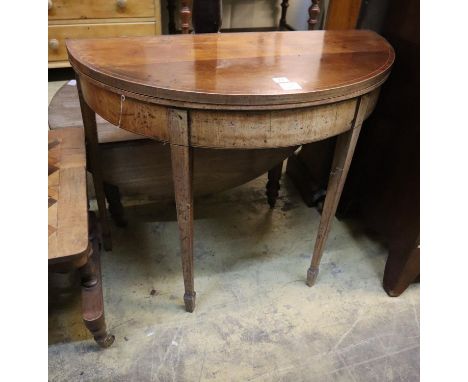 A George III inlaid mahogany D shaped folding card table, width 88cm, depth 42cm, height 75cm