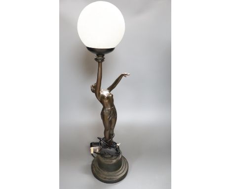 An Art Deco style bronzed resin figural table lamp, semi-nude female holding glass shade aloft, 66cm overall