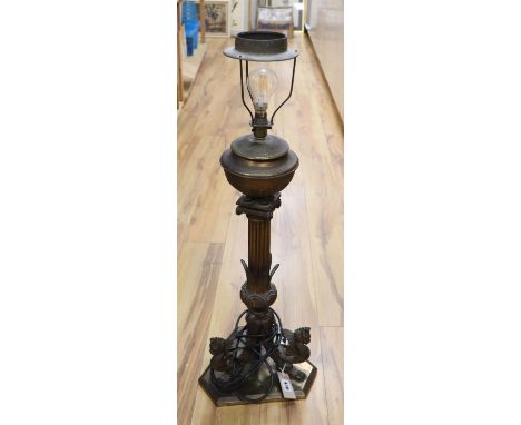 A 19th century gilt bronze and brass oil lamp on tri-form dragon supports (converted for electricity)