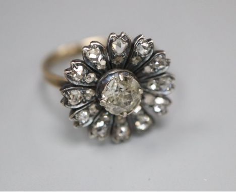 An antique yellow metal and diamond set circular cluster ring, (adapted?), size K/L, gross 3.5 grams, set with old round and 