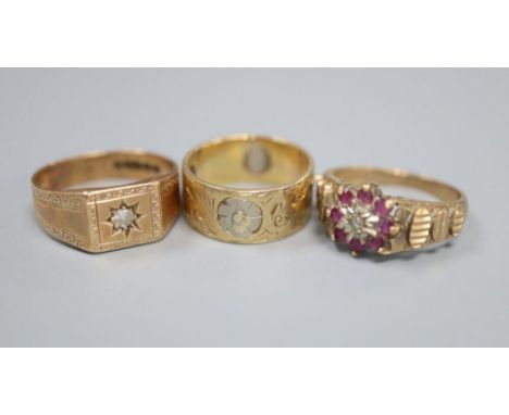 A 9ct gold and diamond gypsy-set ring, a 9ct gold, ruby and diamond cluster ring and a two-colour 9ct gold engraved ring, gro