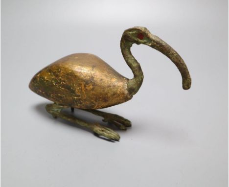 A bronze and wood model of an Ibis, the shaped body with heavy traces of gilt, the bronze head and legs cast separately and i