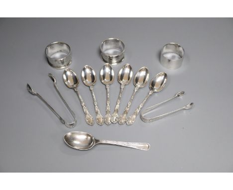 Three silver napkin rings, a set of six silver teaspoons, one other spoon and two pairs of silver sugar tongs, 7oz.