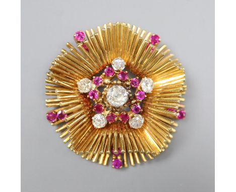 A late 1950's 18ct gold, ruby and diamond cluster set stylised flower head pendant brooch, 45mm, gross 39.3 grams.CONDITION: 