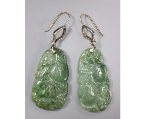 A pair of yellow and white metal mounted carved jade and diamond chip set earrings, jade 35mm, gross 14.6 grams.CONDITION: Nu