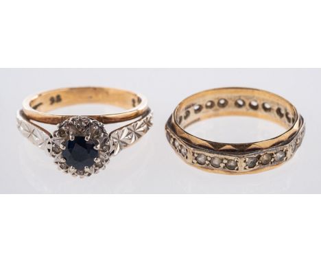 Two 9ct gold rings. including a  sapphire and diamond cluster ring, the circular cut sapphire claw set within a surround of e