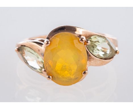 A 9ct yellow gold ring, set with an oval-cut opal with a marquise-cut green stone set to each side, UK import mark, size K, 2