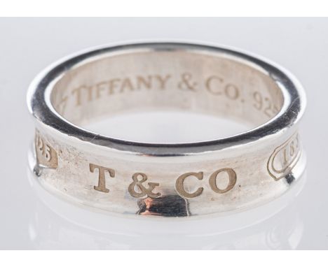 Tiffany & Co. A silver concave style ring, engraved to the outside '925, T & CO, 1837', engraved to the inside '1997 Tiffany 