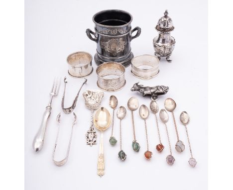 A group of silver items, comprising of; three napkin rings, a pepperette, a recumbent cow (finial) fully hall marked, two pai