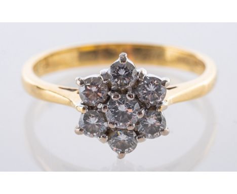 An 18ct yellow gold daisy ring, set with seven brilliant cut diamonds, diamonds approx. 0.45 carat total, UK hallmark, size M