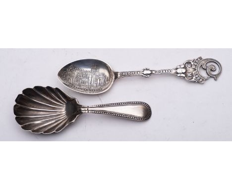 A Victorian silver caddy spoon, Exeter 1876, with shell bowl and feather banded edge, together with a Crediton Millenary spoo
