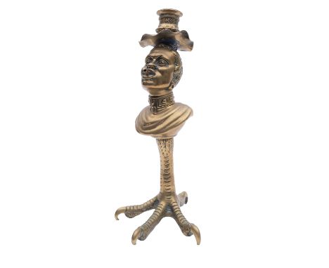 A gilt brass table lighter in the form of a bust of a slave, adapted as a candlestick, 19th century and later; mounted on a c