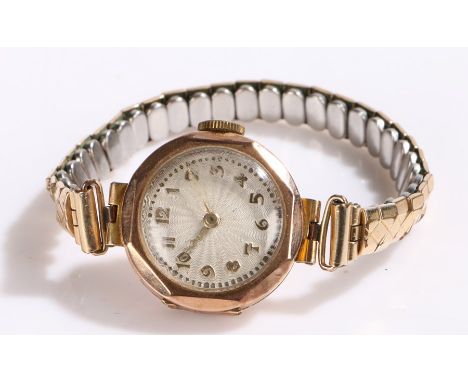 9 carat gold ladies wristwatch, the white engine turned dial with Arabic markers, manual wound, the case 25mm diameter, on a 