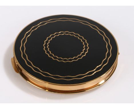 Stratton gilt metal compact, the lid with gilt wavy line decoration on a black ground, the interior with mirror and banded po