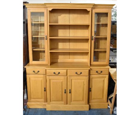 A Modern Light Oak Breakfront Dresser, the Base with Four Drawers Over Cupboards, Raised Central Three Shelf Open Area, Flank