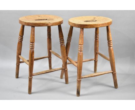 A Pair of Vintage Stools on Turned Tapering Supports with Box Stretcher and Oval Top with Central Cut Out, 56cms High 