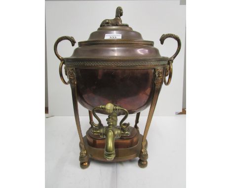 A Georgian copper tea urn with domed lid and sphinx finial, bird of prey head and ring handles, brass top with turned ivory s