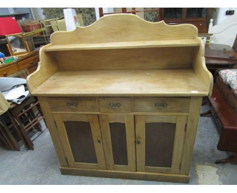 A Victorian/Edwardian pine sideboard shaped 3/4 extended back with single shelf over three drawers and two cupboard doors on 