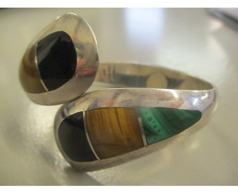 A Mexican silver bangle inset with malachite, Tiger's Eye and black onyx 53.2g 