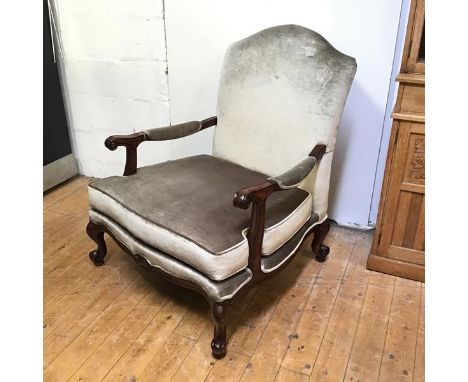 A reproduction chair in the Georgian style, of large proportions, with soft grey velvet upholstery and walnut stained show wo